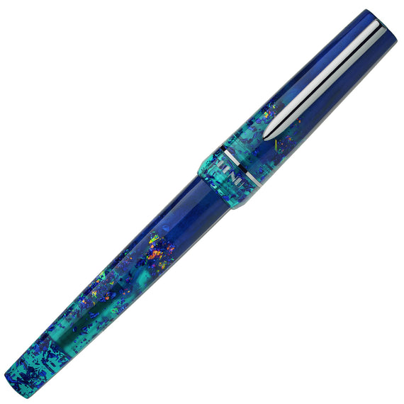 Blue and turquoise speckled pen with a silver clip on a white background