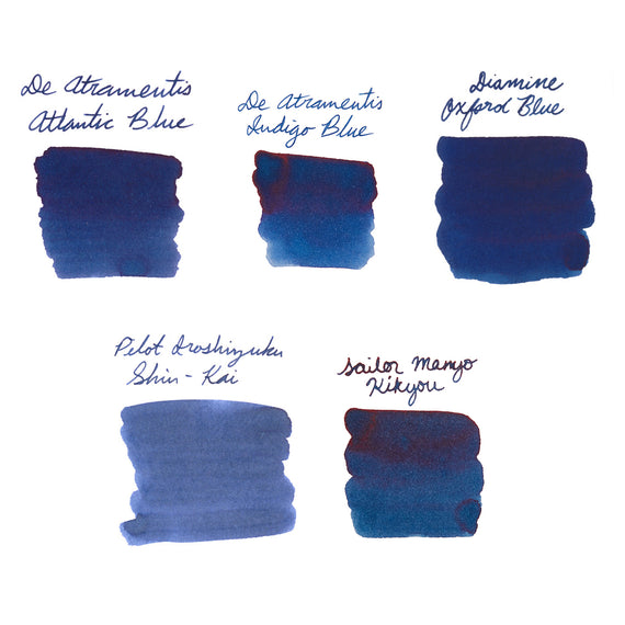 Collection of dark blue ink swatches from various brands on a white background