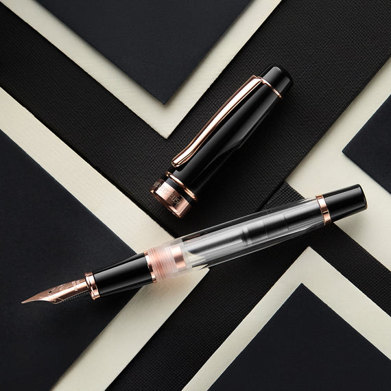 A fountain pen on a black and white geometric patterned surface