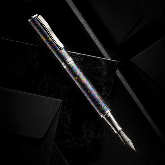 Fountain pen with multicolored barrel on a black background