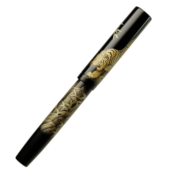 Decorative pen with tiger design on a white background