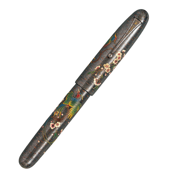Decorative pen with floral and bird patterns on a white background