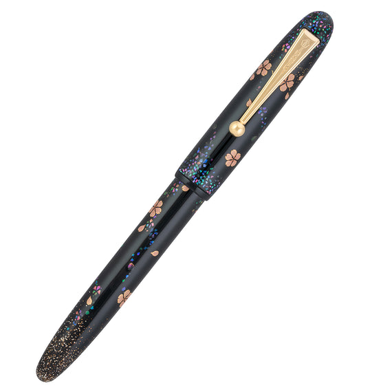 Decorative pen with black and gold design on a white background