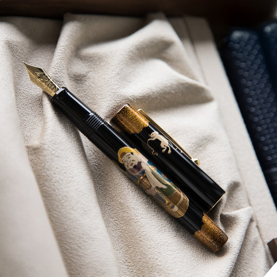 Decorative fountain pen with artistic design on a textured surface