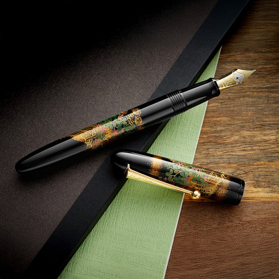 Fountain pen with decorative design on a wooden surface