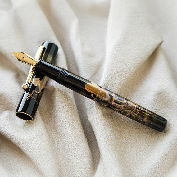 Fountain pen with decorative design on a beige fabric background