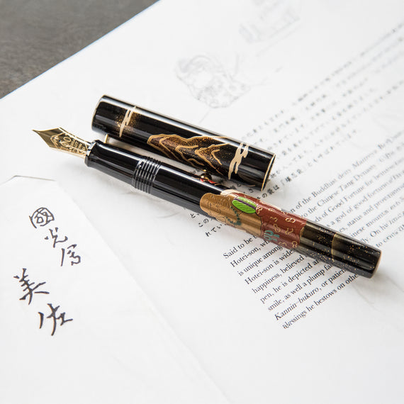 Fountain pen with decorative cap on a piece of paper