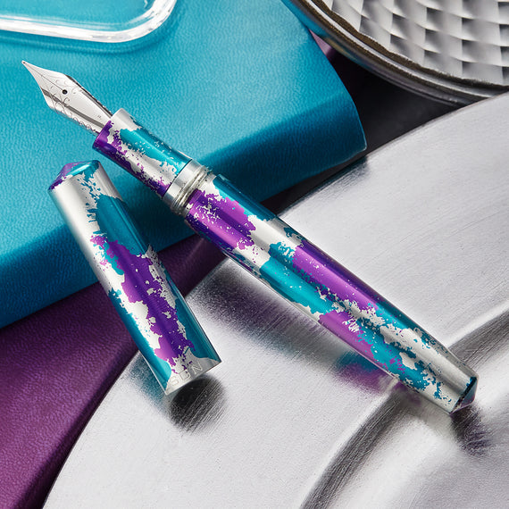 Fountain pen with purple and blue design on a textured surface