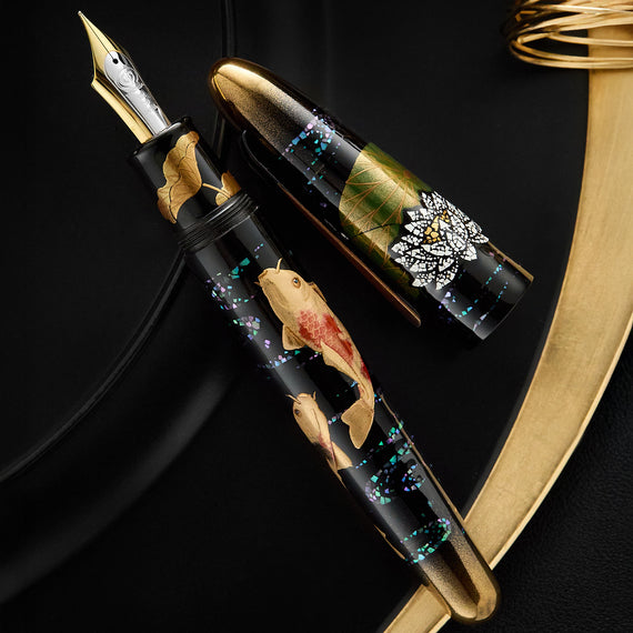 Fountain pen with decorative design on a black background