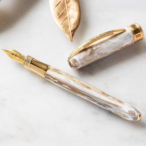 Fountain pen with gold accents on a light surface